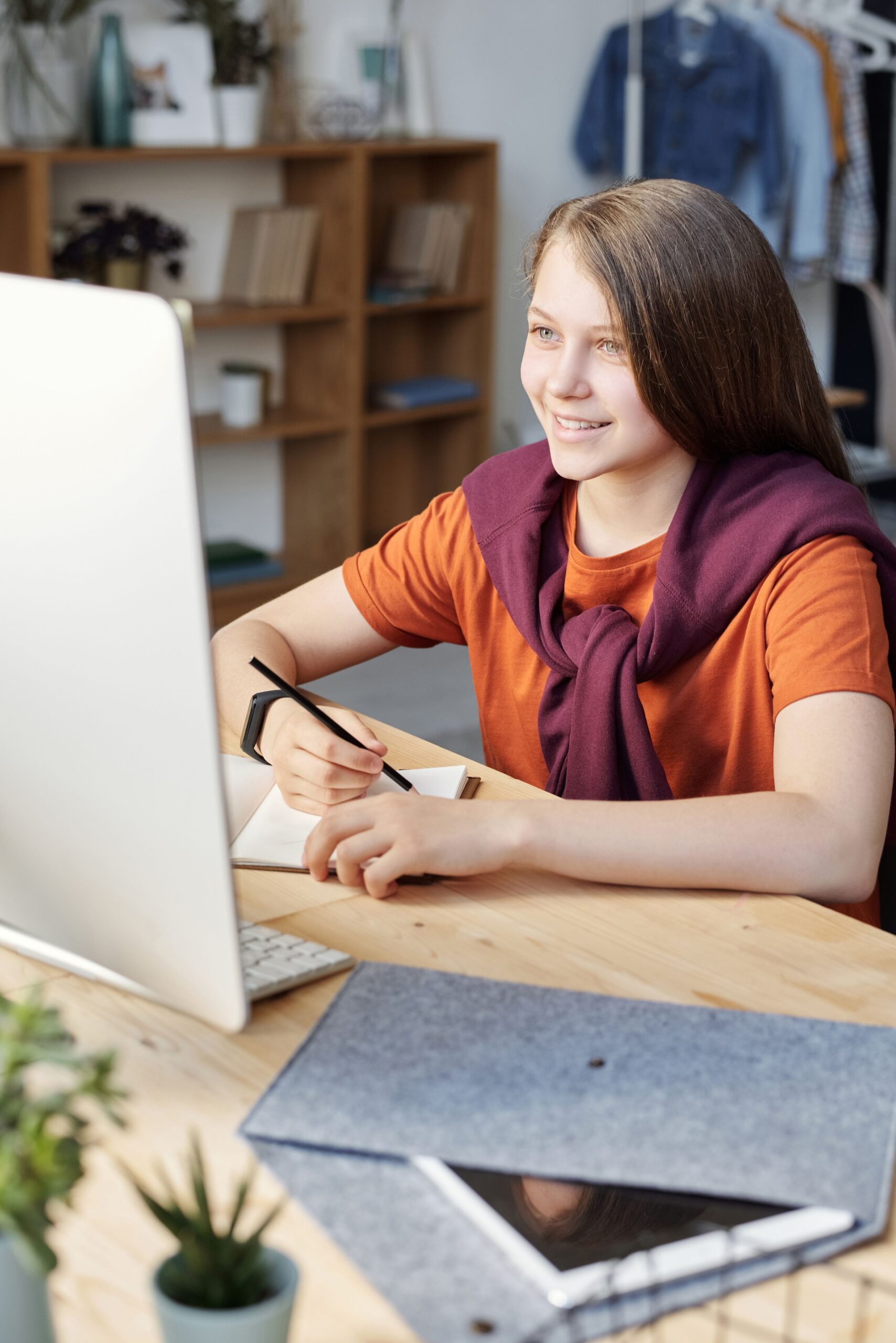 Teenager smiling while working at a computer